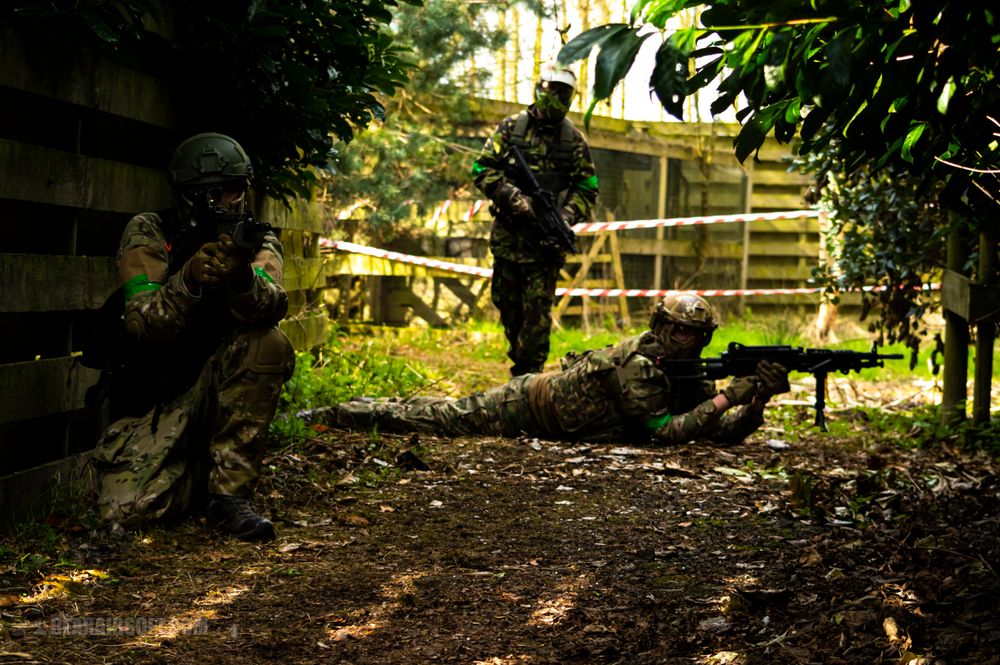 Airsoft squad defending a woodland objective
