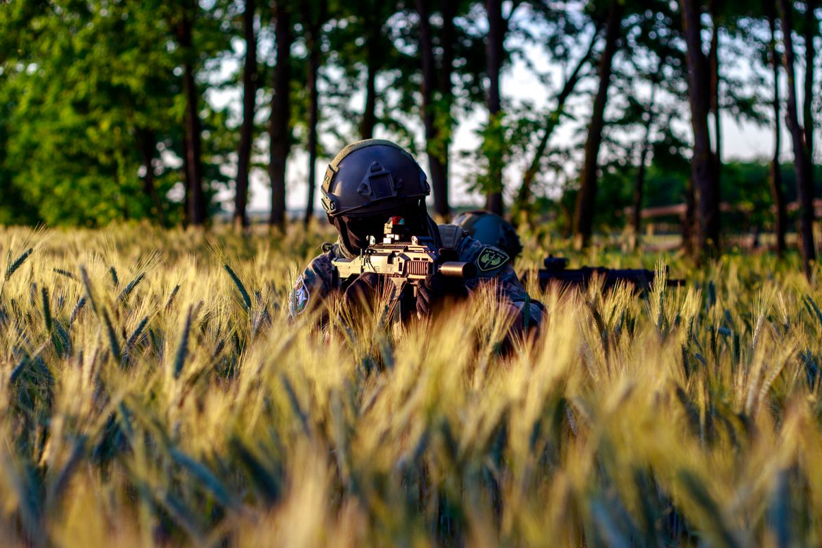 Airsoft player moving through a field during a game