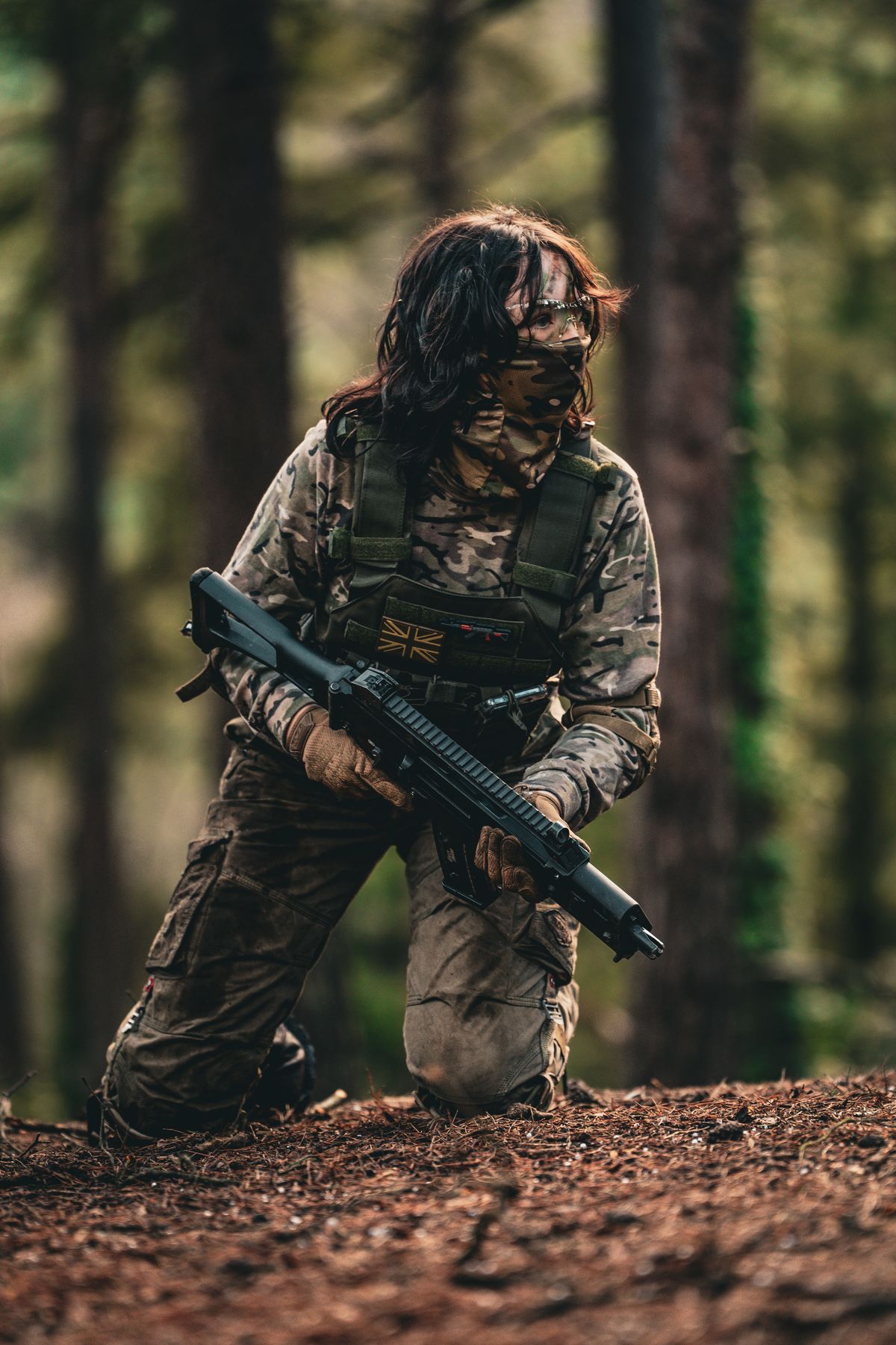 Airsoft player wearing protective equipment in woodland